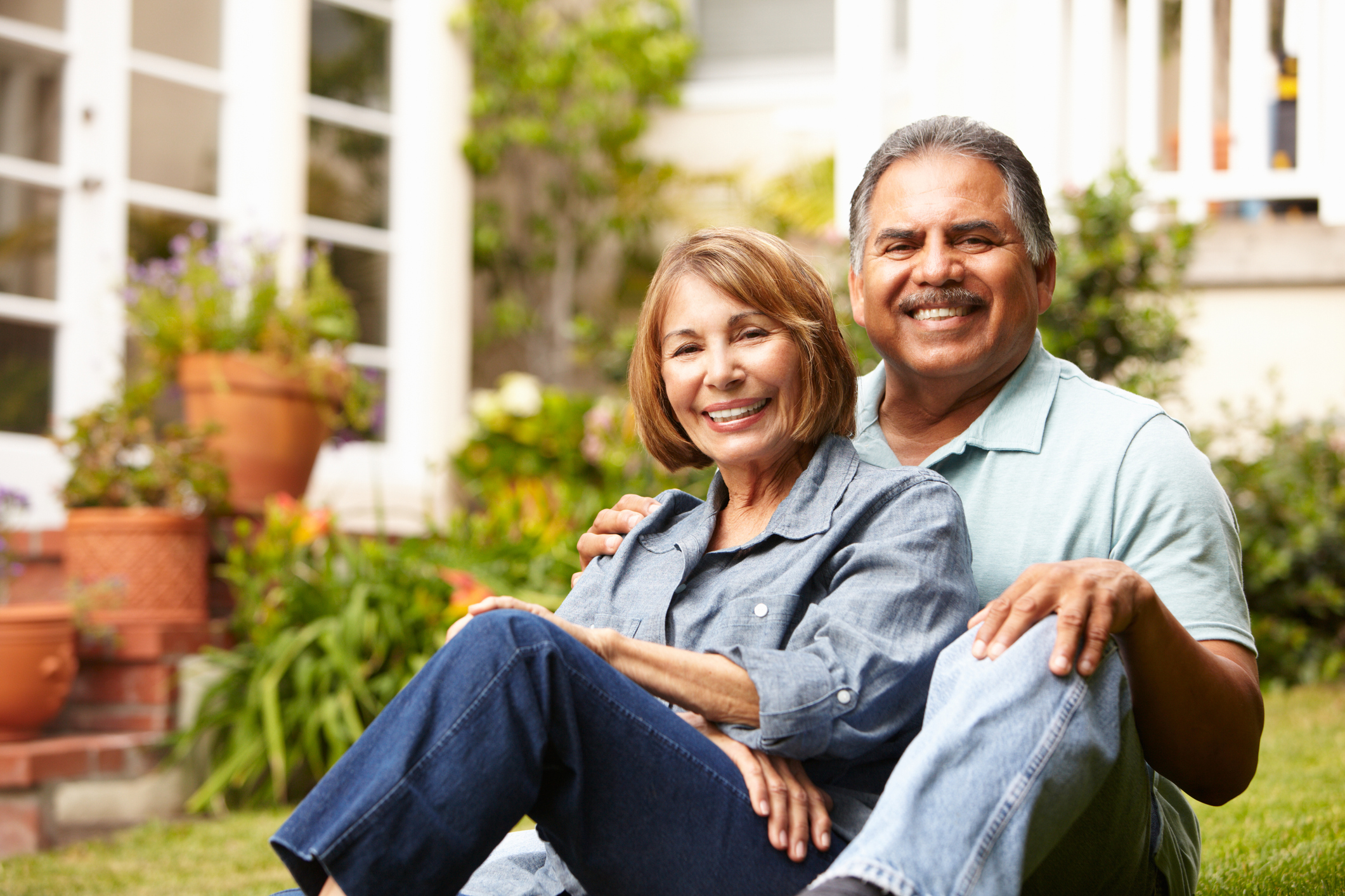 A senior couple relaxing in their garden at home